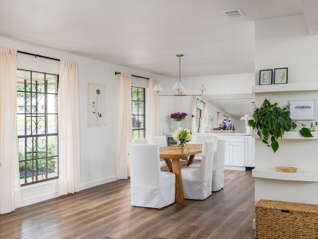2300 Toulouse Dr, Austin, TX 78748 - dining space with dark wood-type flooring, a chandelier, and baseboards