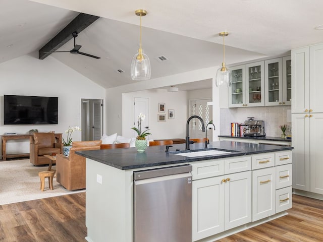2300 Toulouse Dr, Austin, TX 78748 - kitchen with dishwasher, a sink, wood finished floors, and dark countertops