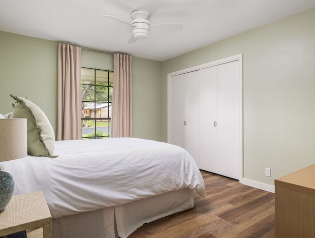 bedroom with wood finished floors, baseboards, a closet, and a ceiling fan