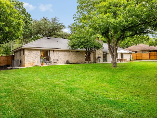2300 Toulouse Dr, Austin, TX 78748 - back of house with central AC unit, a patio, stone siding, and metal roof