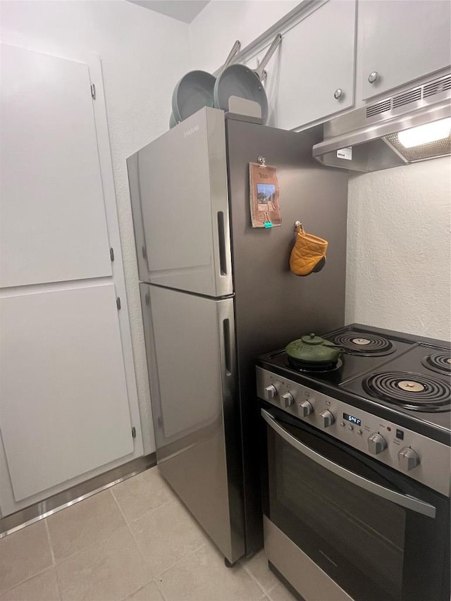 4701 Red River St Unit 104, Austin, TX 78751 - kitchen featuring electric stove, under cabinet range hood, white cabinets, and light tile patterned floors
