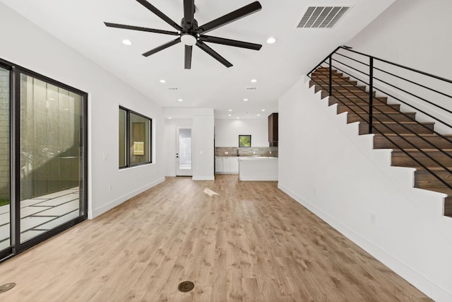 4407 Merle Dr Unit B, Austin, TX 78645 - unfurnished living room with light wood-style floors, recessed lighting, a ceiling fan, stairs, and baseboards