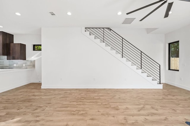 4407 Merle Dr Unit B, Austin, TX 78645 - unfurnished living room featuring light wood-type flooring, stairway, plenty of natural light, and recessed lighting