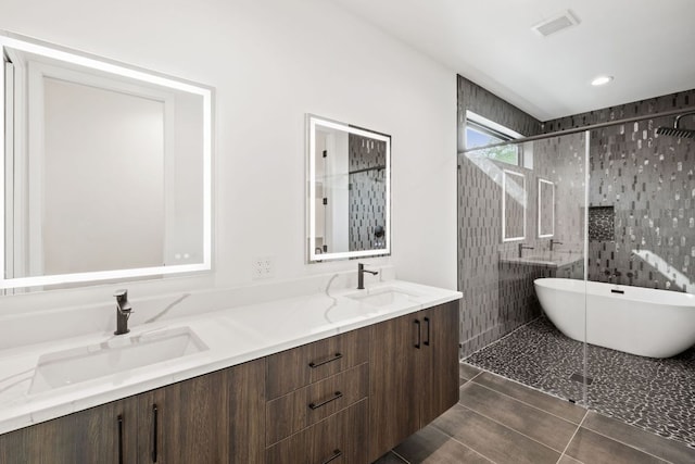 4407 Merle Dr Unit B, Austin, TX 78645 - bathroom featuring a stall shower, double vanity, a freestanding tub, and tile patterned flooring