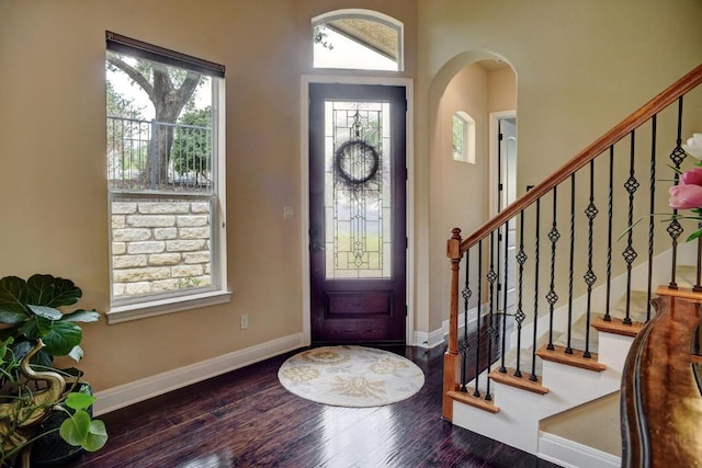15208 Origins Ln, Austin, TX 78734 - foyer entrance featuring arched walkways, wood finished floors, stairway, and baseboards