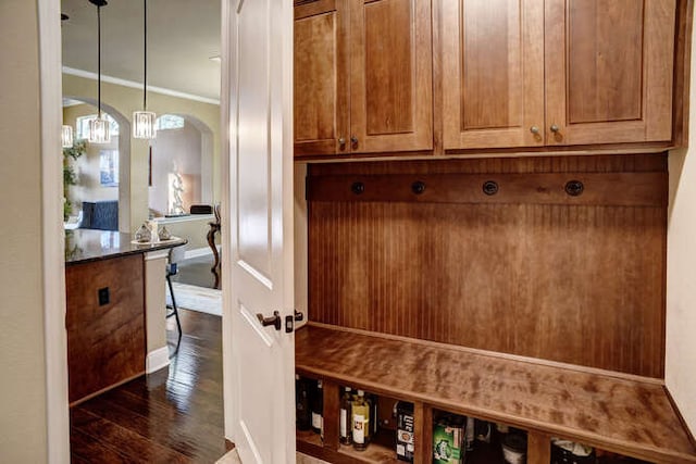 15208 Origins Ln, Austin, TX 78734 - mudroom with ornamental molding, dark wood-type flooring, arched walkways, and a chandelier