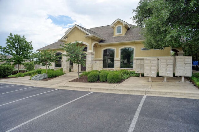 15208 Origins Ln, Austin, TX 78734 - view of front of property with uncovered parking, stucco siding, and stone siding