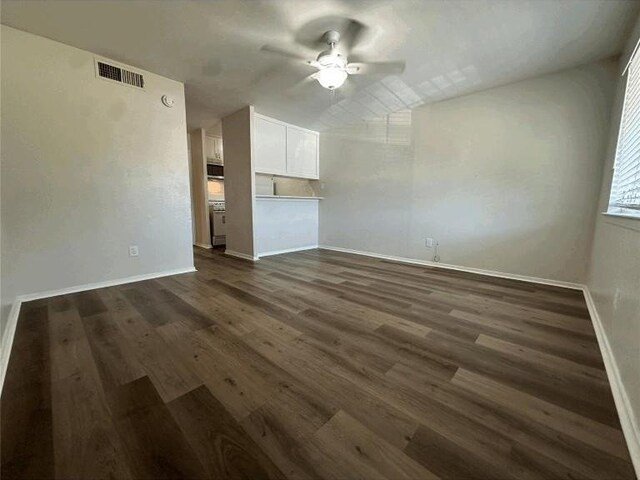 5207 Tahoe Trl Unit A, B, C, & D, Austin, TX 78745 - unfurnished living room featuring a ceiling fan, baseboards, and dark wood-type flooring