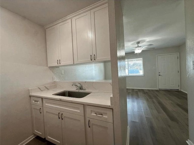5207 Tahoe Trl Unit A, B, C, & D, Austin, TX 78745 - kitchen featuring a sink, white cabinets, ceiling fan, dark wood-type flooring, and baseboards