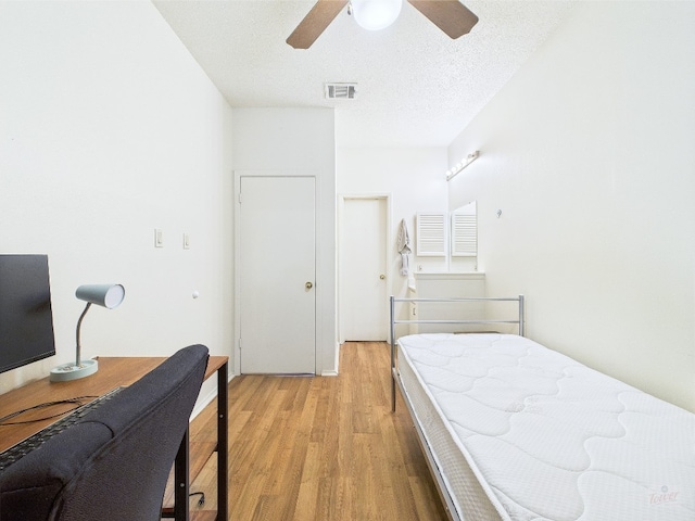 2905 Swisher St Unit 205, Austin, TX 78705 - bedroom featuring light wood-style flooring, ceiling fan, a textured ceiling, and an office area