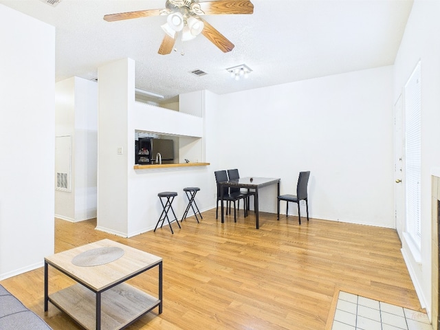 2905 Swisher St Unit 205, Austin, TX 78705 - living area with wood finished floors, a ceiling fan, and baseboards