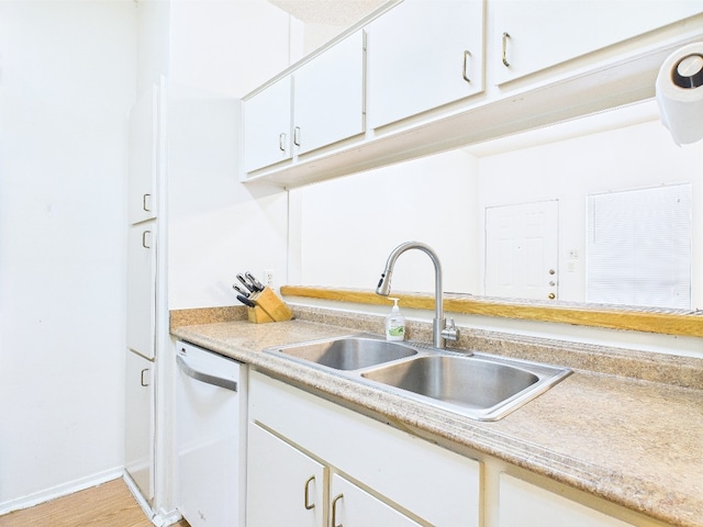 2905 Swisher St Unit 205, Austin, TX 78705 - kitchen featuring dishwasher, a sink, light countertops, white cabinetry, and baseboards