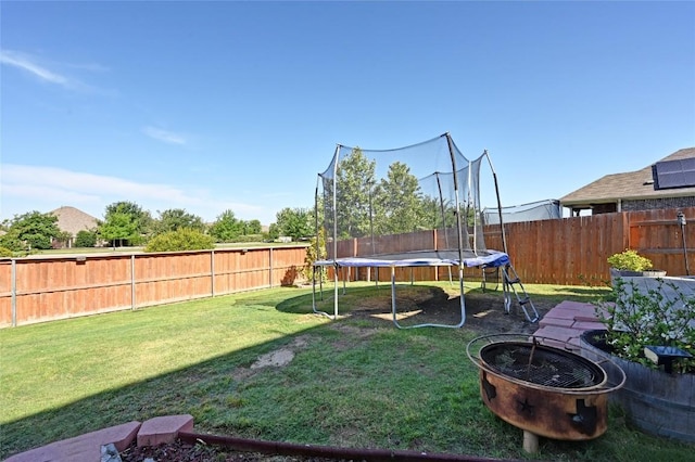 160 Thornless Cir, Buda, TX 78610 - view of yard with a trampoline and an outdoor fire pit