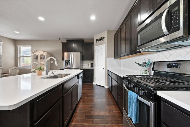 160 Thornless Cir, Buda, TX 78610 - kitchen featuring stainless steel appliances, a sink, light countertops, dark wood-type flooring, and recessed lighting