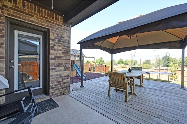 160 Thornless Cir, Buda, TX 78610 - deck with a trampoline, a gazebo, a fenced backyard, and outdoor dining space