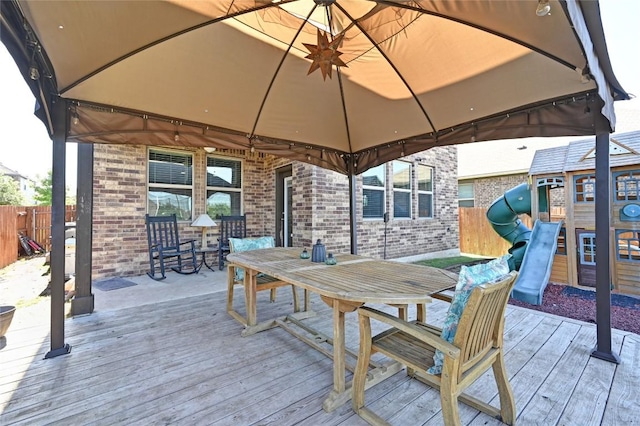 160 Thornless Cir, Buda, TX 78610 - wooden terrace with a gazebo, a playground, outdoor dining area, and fence