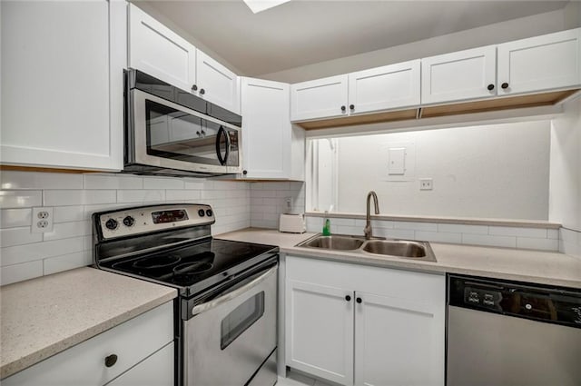 806 W 24th St Unit 114, Austin, TX 78705 - kitchen featuring stainless steel appliances, a sink, white cabinetry, and decorative backsplash