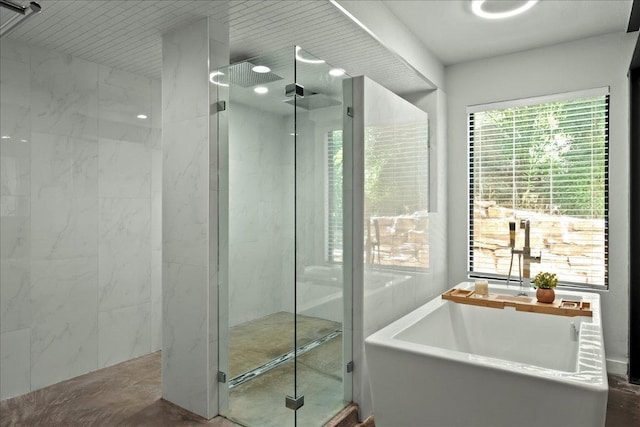 909 Electra, Lakeway, TX 78734 - bathroom featuring a stall shower and a freestanding bath