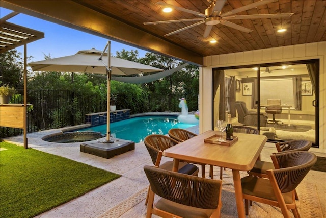 909 Electra, Lakeway, TX 78734 - swimming pool featuring a ceiling fan, an in-ground hot tub, outdoor dining space, a patio, and a fenced backyard