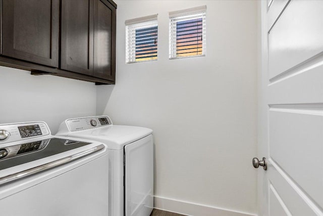 laundry room featuring washing machine and dryer and cabinet space