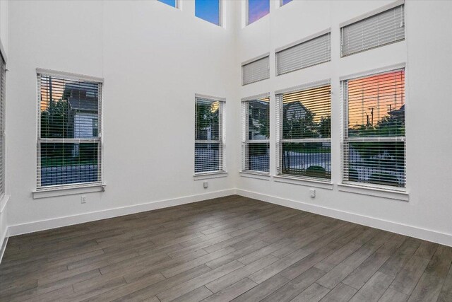 301 Jeffrey David Ln W, Austin, TX 78717 - unfurnished room featuring dark wood-style floors, baseboards, and a high ceiling