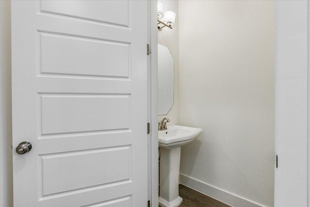301 Jeffrey David Ln W, Austin, TX 78717 - bathroom with baseboards, wood finished floors, and a sink