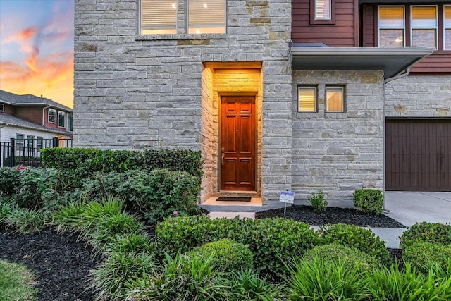 301 Jeffrey David Ln W, Austin, TX 78717 - entrance to property featuring stone siding, concrete driveway, and a garage