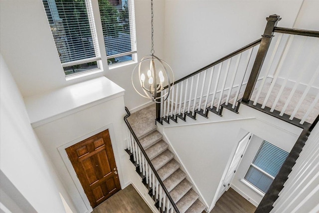 301 Jeffrey David Ln W, Austin, TX 78717 - stairway featuring a chandelier and wood finished floors