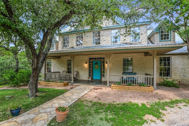 108 Tumbleweed Trl, Austin, TX 78733 - view of front of property featuring a porch, stone siding, and metal roof