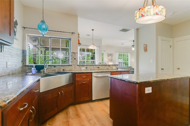 108 Tumbleweed Trl, Austin, TX 78733 - kitchen featuring stainless steel dishwasher, light wood finished floors, backsplash, a sink, and stone countertops