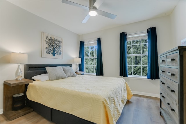 108 Tumbleweed Trl, Austin, TX 78733 - bedroom with wood finished floors, baseboards, and a ceiling fan