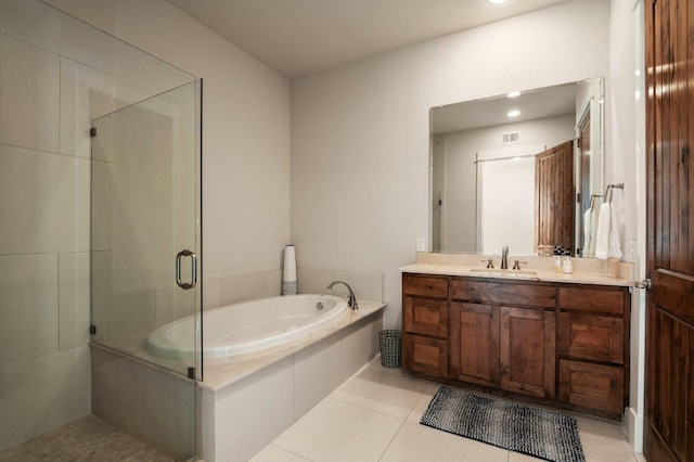 full bathroom featuring a shower stall, a bath, vanity, and tile patterned floors