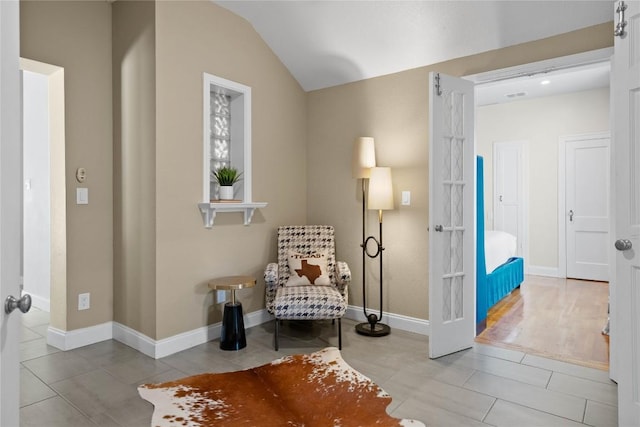 2106 Kenwood Ave, Austin, TX 78704 - sitting room featuring tile patterned floors, vaulted ceiling, and baseboards