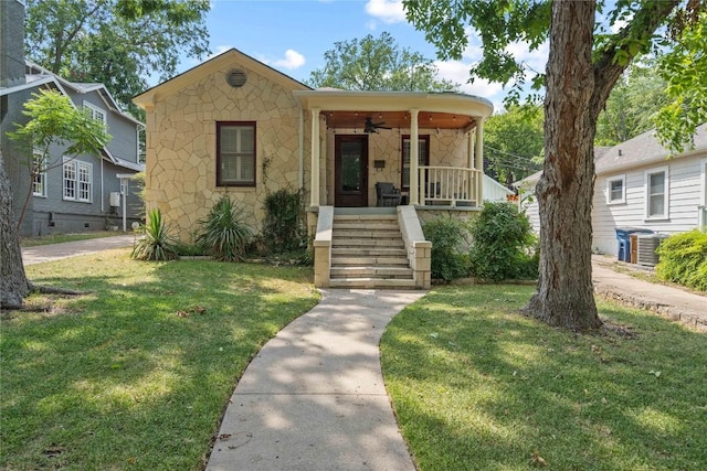2106 Kenwood Ave, Austin, TX 78704 - view of front of property featuring stone siding, a front lawn, covered porch, and stairway