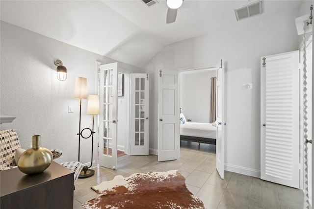 2106 Kenwood Ave, Austin, TX 78704 - bedroom featuring french doors, light tile patterned floors, vaulted ceiling, a ceiling fan, and baseboards
