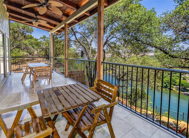 balcony with outdoor dining space and ceiling fan