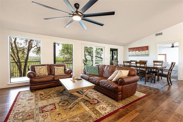 living room featuring lofted ceiling, plenty of natural light, ceiling fan, and dark wood-style floors