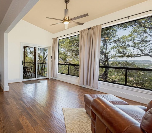 living room featuring a ceiling fan, baseboards, lofted ceiling, and hardwood / wood-style floors