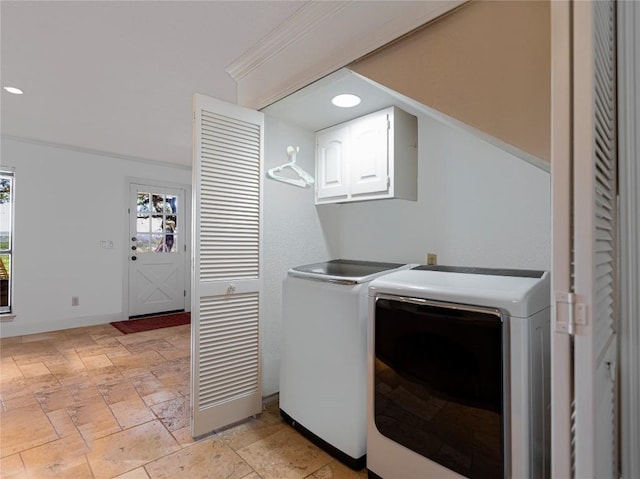 laundry area with healthy amount of natural light, cabinet space, washer and dryer, stone tile flooring, and recessed lighting