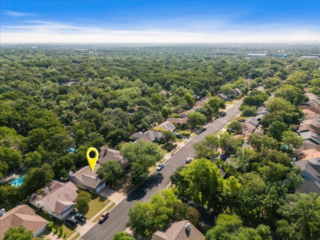 aerial view of residential area featuring a forest