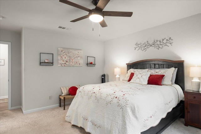bedroom with light colored carpet, baseboards, and ceiling fan