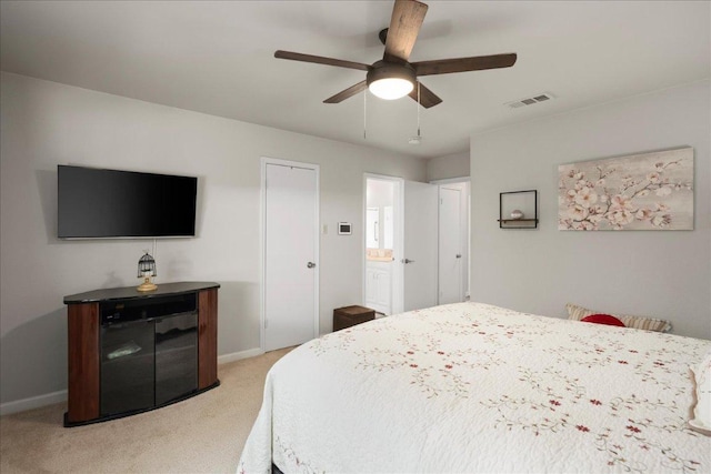 bedroom with light colored carpet, baseboards, and a ceiling fan