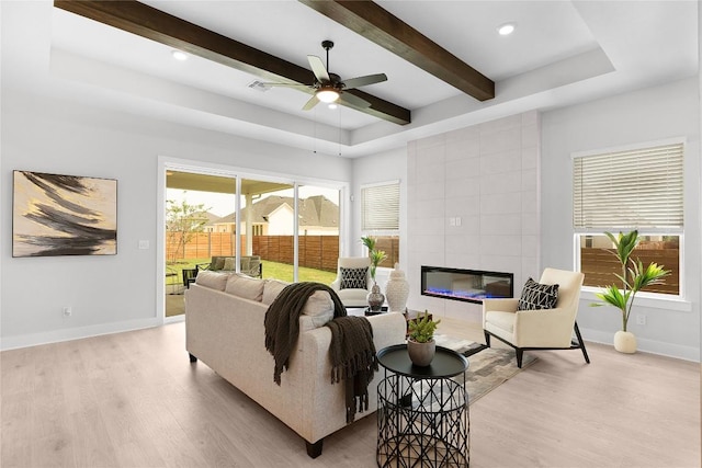 232 San Xavier St, Georgetown, TX 78633 - living area featuring light wood-style floors, a ceiling fan, beamed ceiling, a fireplace, and recessed lighting