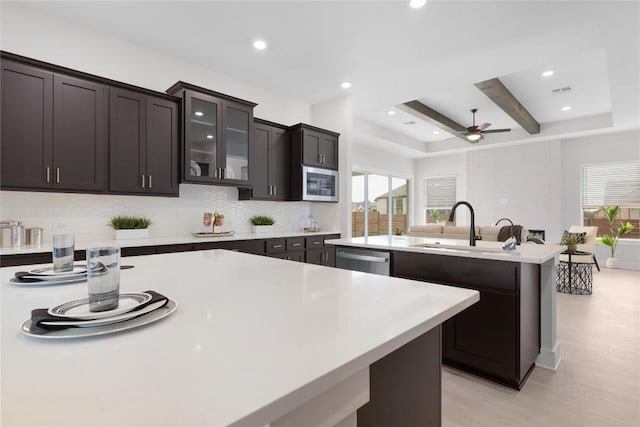 232 San Xavier St, Georgetown, TX 78633 - kitchen featuring a sink, appliances with stainless steel finishes, ceiling fan, a kitchen island with sink, and light countertops