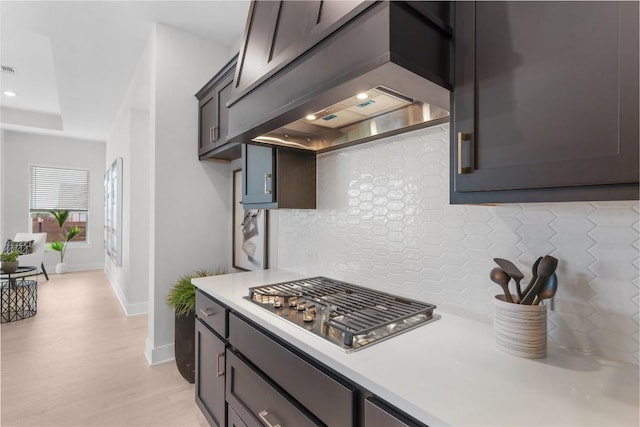232 San Xavier St, Georgetown, TX 78633 - kitchen featuring light countertops, tasteful backsplash, stainless steel gas cooktop, and baseboards