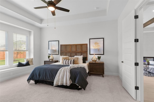 232 San Xavier St, Georgetown, TX 78633 - bedroom with a tray ceiling, light carpet, a ceiling fan, and baseboards