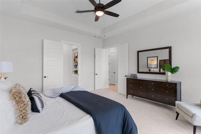 232 San Xavier St, Georgetown, TX 78633 - bedroom featuring light colored carpet, a raised ceiling, and a ceiling fan