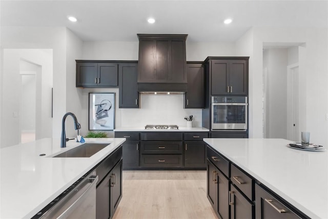 232 San Xavier St, Georgetown, TX 78633 - kitchen featuring stainless steel appliances, a sink, premium range hood, light countertops, and recessed lighting