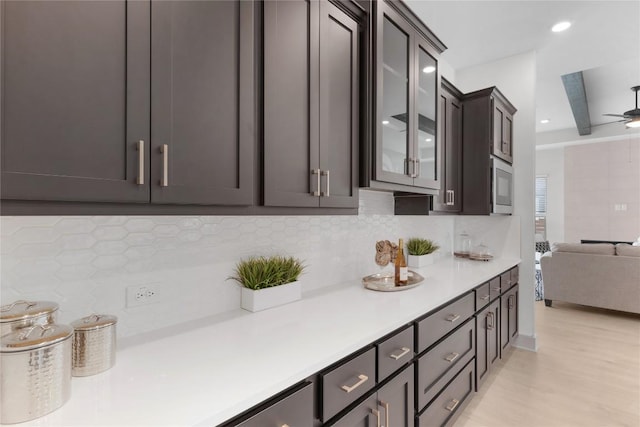 232 San Xavier St, Georgetown, TX 78633 - kitchen with light countertops, tasteful backsplash, glass insert cabinets, open floor plan, and recessed lighting
