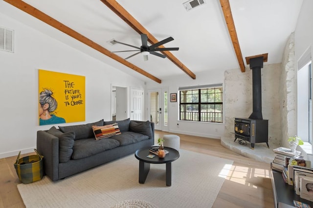 14406 Tucumcari Trl, Austin, TX 78734 - living area with wood finished floors, a wood stove, ceiling fan, and baseboards